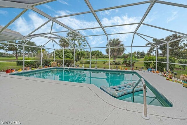 view of pool with a lanai and a patio area