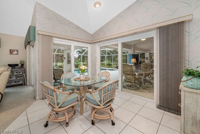 dining space with vaulted ceiling, light tile patterned floors, light carpet, and a sunroom