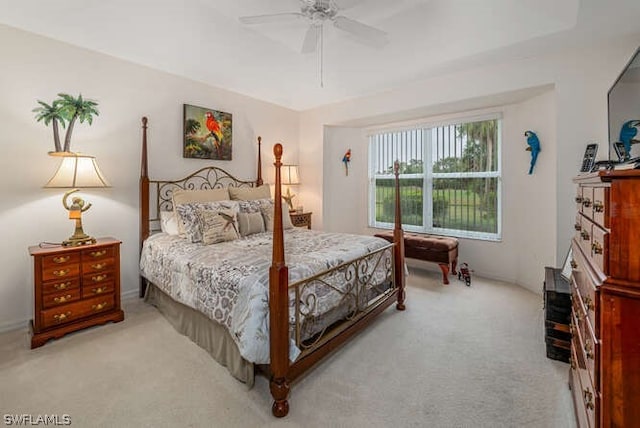 bedroom with a ceiling fan and light colored carpet