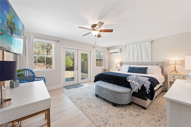 bedroom with french doors, ceiling fan, an AC wall unit, access to outside, and light wood-type flooring