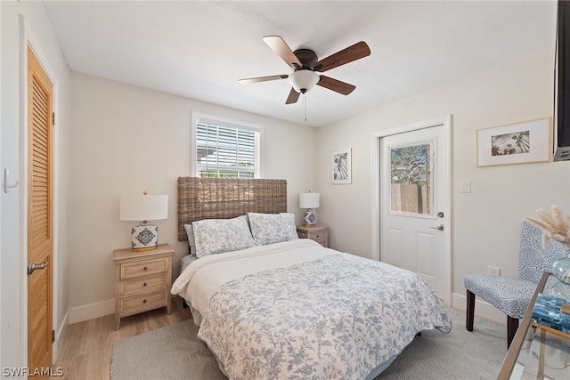 bedroom with a closet, ceiling fan, and light wood-type flooring