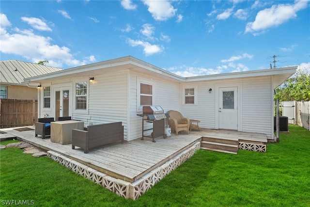 rear view of property with central air condition unit, a wooden deck, a yard, and an outdoor living space