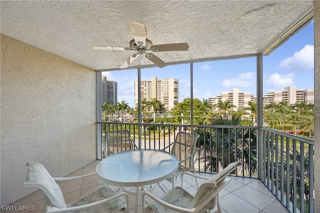 sunroom featuring ceiling fan