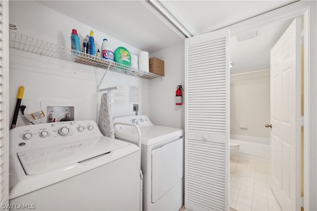 laundry room with washer and clothes dryer, washer hookup, hookup for an electric dryer, and light tile flooring