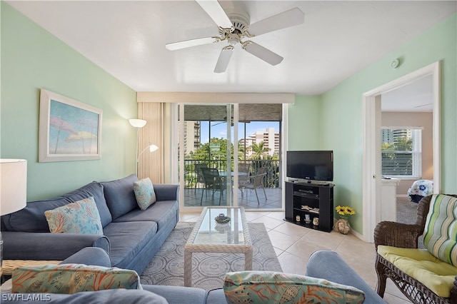 living room featuring ceiling fan, a healthy amount of sunlight, and light tile floors