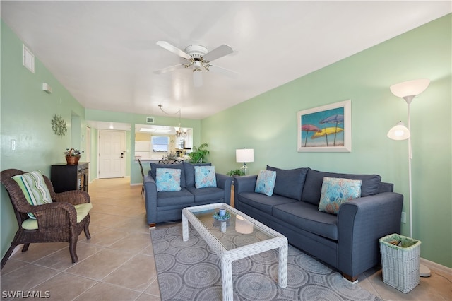 living room with light tile flooring and ceiling fan with notable chandelier