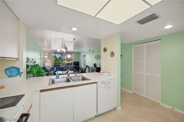 kitchen with a notable chandelier, light tile floors, sink, white dishwasher, and white cabinets