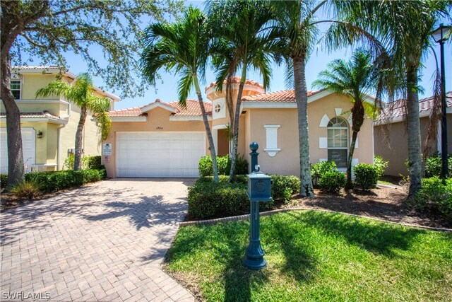 mediterranean / spanish-style home with a garage