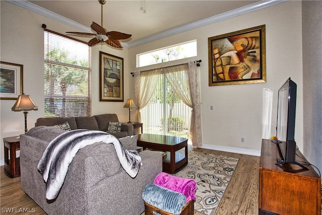 living room featuring hardwood / wood-style flooring, ornamental molding, and ceiling fan