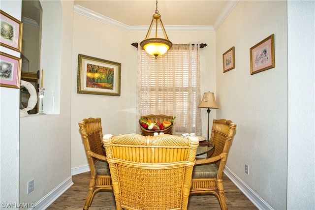 dining space featuring crown molding and dark wood-type flooring