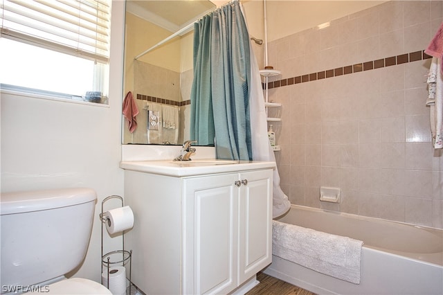 full bathroom featuring shower / tub combo with curtain, hardwood / wood-style flooring, vanity, toilet, and crown molding