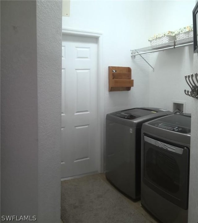 clothes washing area featuring washer and clothes dryer