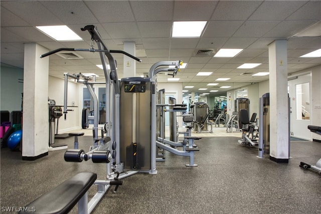 exercise room with a paneled ceiling