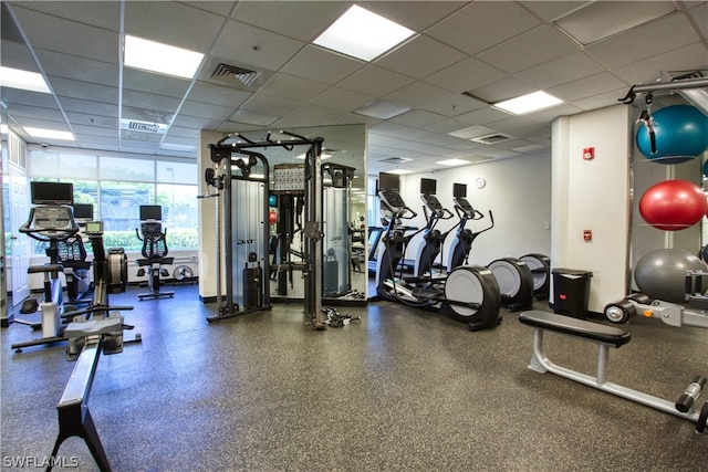 exercise room featuring a paneled ceiling