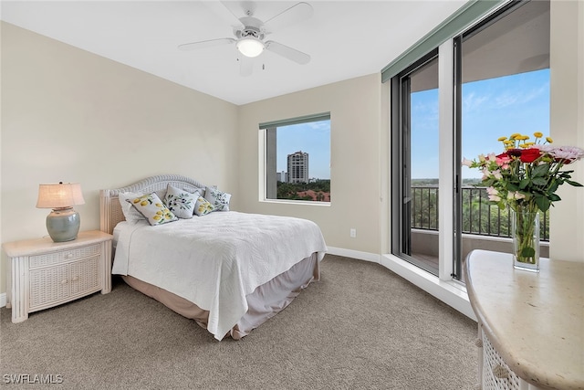 carpeted bedroom with multiple windows, access to exterior, and ceiling fan