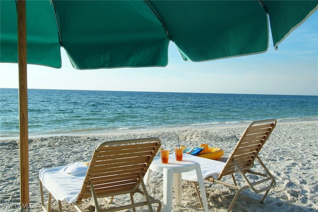 exterior space featuring a beach view and a water view