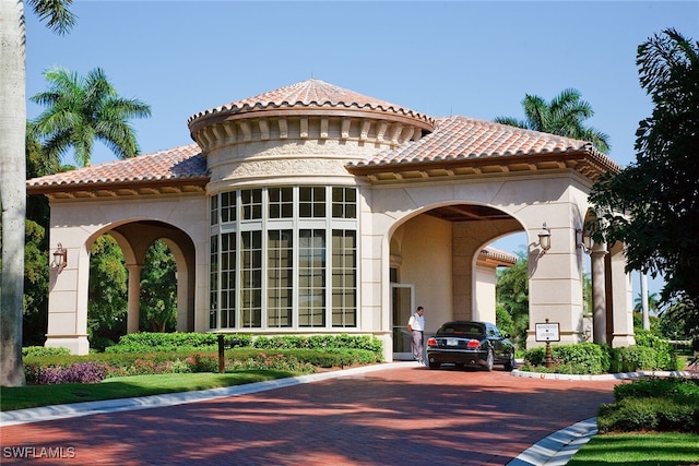 view of building exterior featuring decorative driveway