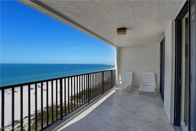 balcony with a beach view and a water view