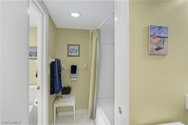 bathroom featuring tile floors and toilet