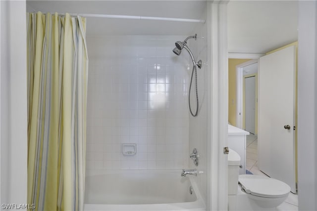 bathroom featuring toilet, shower / tub combo with curtain, and tile flooring