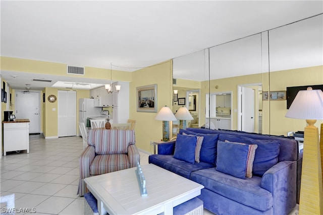 living room with a chandelier and light tile flooring