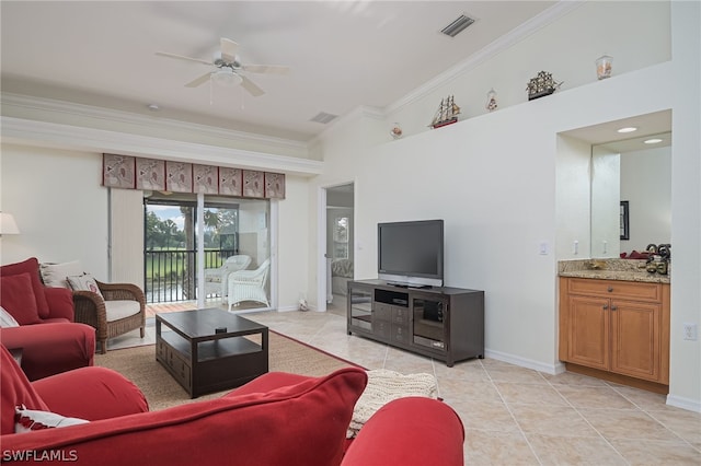 living room featuring light tile floors, crown molding, ceiling fan, and vaulted ceiling