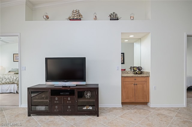 tiled living room featuring ornamental molding, ceiling fan, and vaulted ceiling