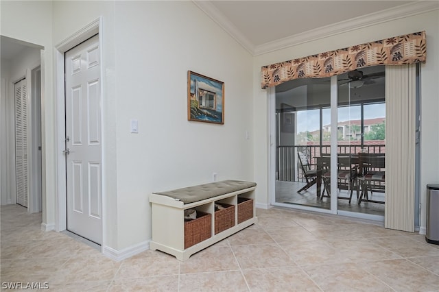 hall with light tile flooring and crown molding