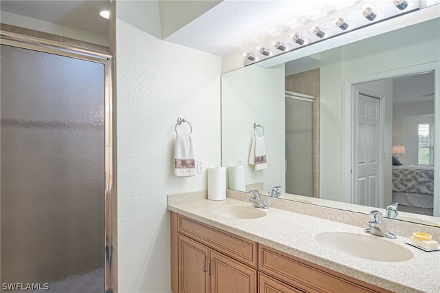 bathroom with walk in shower and dual vanity