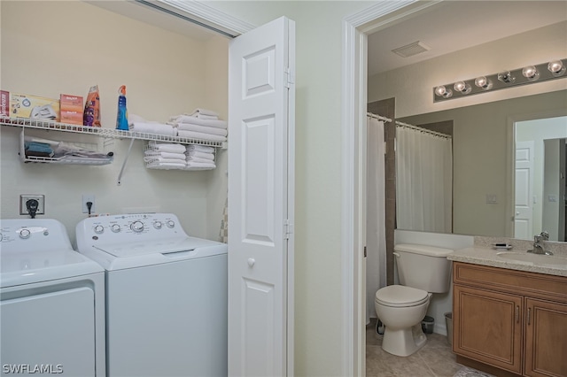 laundry area with electric dryer hookup, light tile floors, sink, and washer and dryer