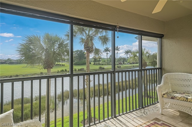 unfurnished sunroom featuring ceiling fan