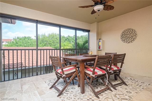 tiled dining area with ceiling fan