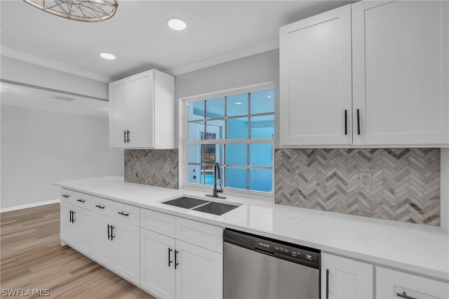 kitchen featuring stainless steel dishwasher, tasteful backsplash, white cabinets, light wood-type flooring, and sink