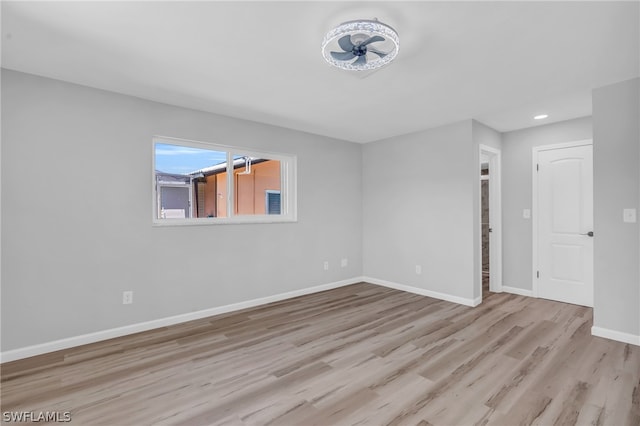 empty room with ceiling fan and light wood-type flooring