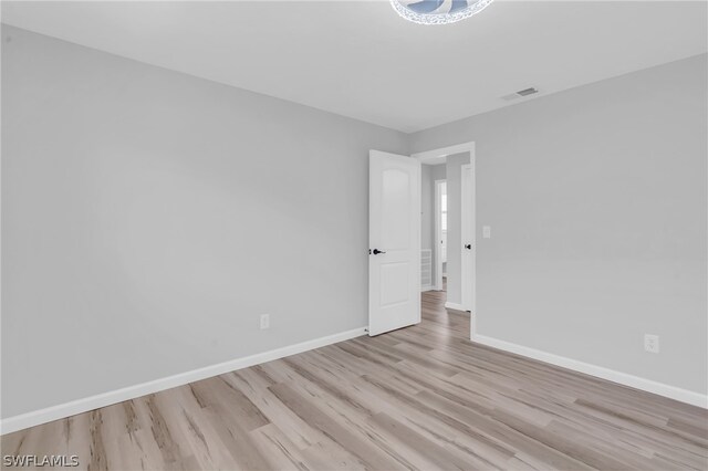 unfurnished room with light hardwood / wood-style flooring