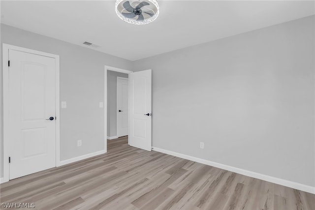 spare room featuring ceiling fan and light hardwood / wood-style flooring