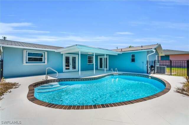 view of swimming pool featuring a patio area and french doors