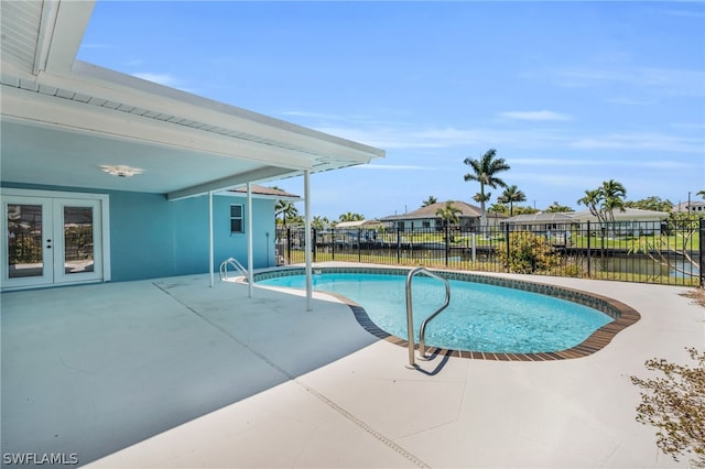 view of pool with a patio area and french doors