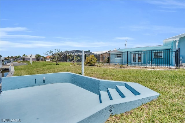 view of pool with a lawn