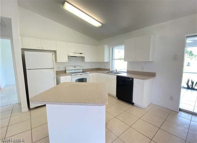 kitchen featuring white appliances, light tile flooring, vaulted ceiling, plenty of natural light, and white cabinetry