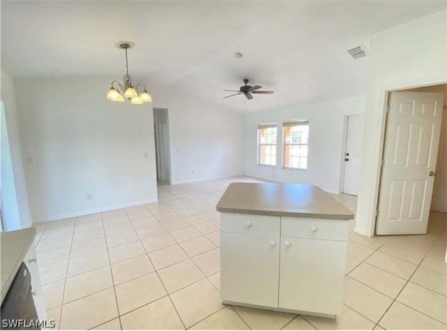 kitchen with light tile floors, white cabinets, pendant lighting, lofted ceiling, and ceiling fan with notable chandelier