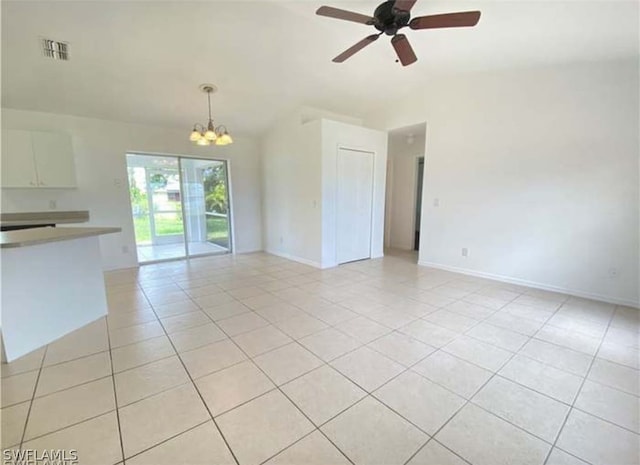 unfurnished living room featuring ceiling fan with notable chandelier and light tile floors