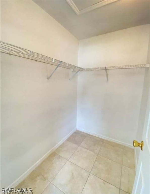 walk in closet featuring light tile flooring