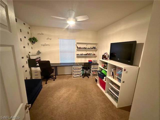 carpeted office space featuring ceiling fan