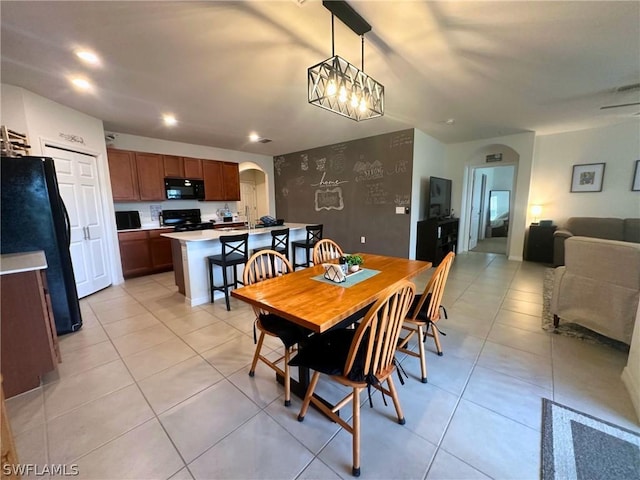 tiled dining space with an inviting chandelier and sink