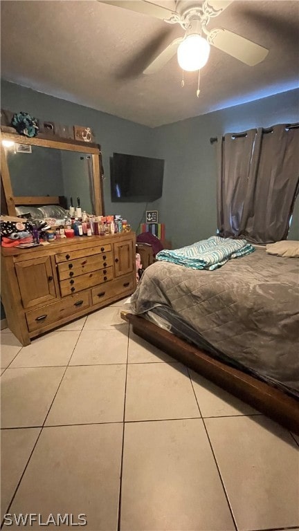 tiled bedroom featuring ceiling fan