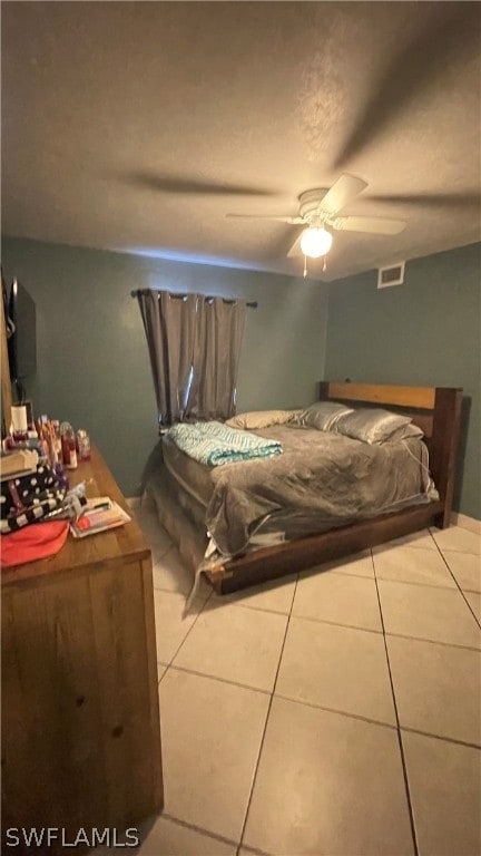 bedroom with ceiling fan and light tile floors