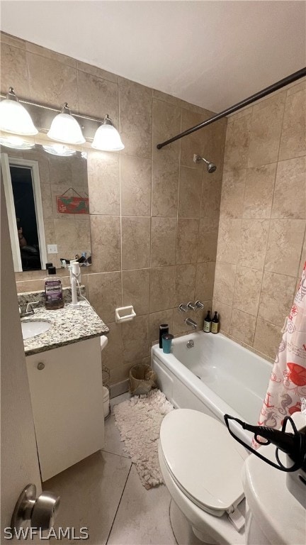 full bathroom featuring tile walls, shower / tub combo, tile floors, toilet, and vanity