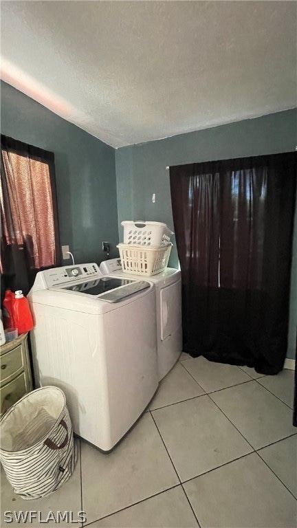 tiled bedroom featuring independent washer and dryer