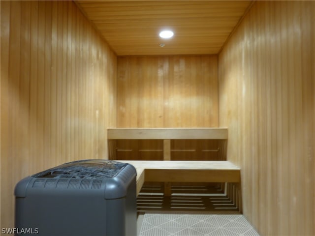 view of sauna / steam room featuring wood ceiling and wood walls